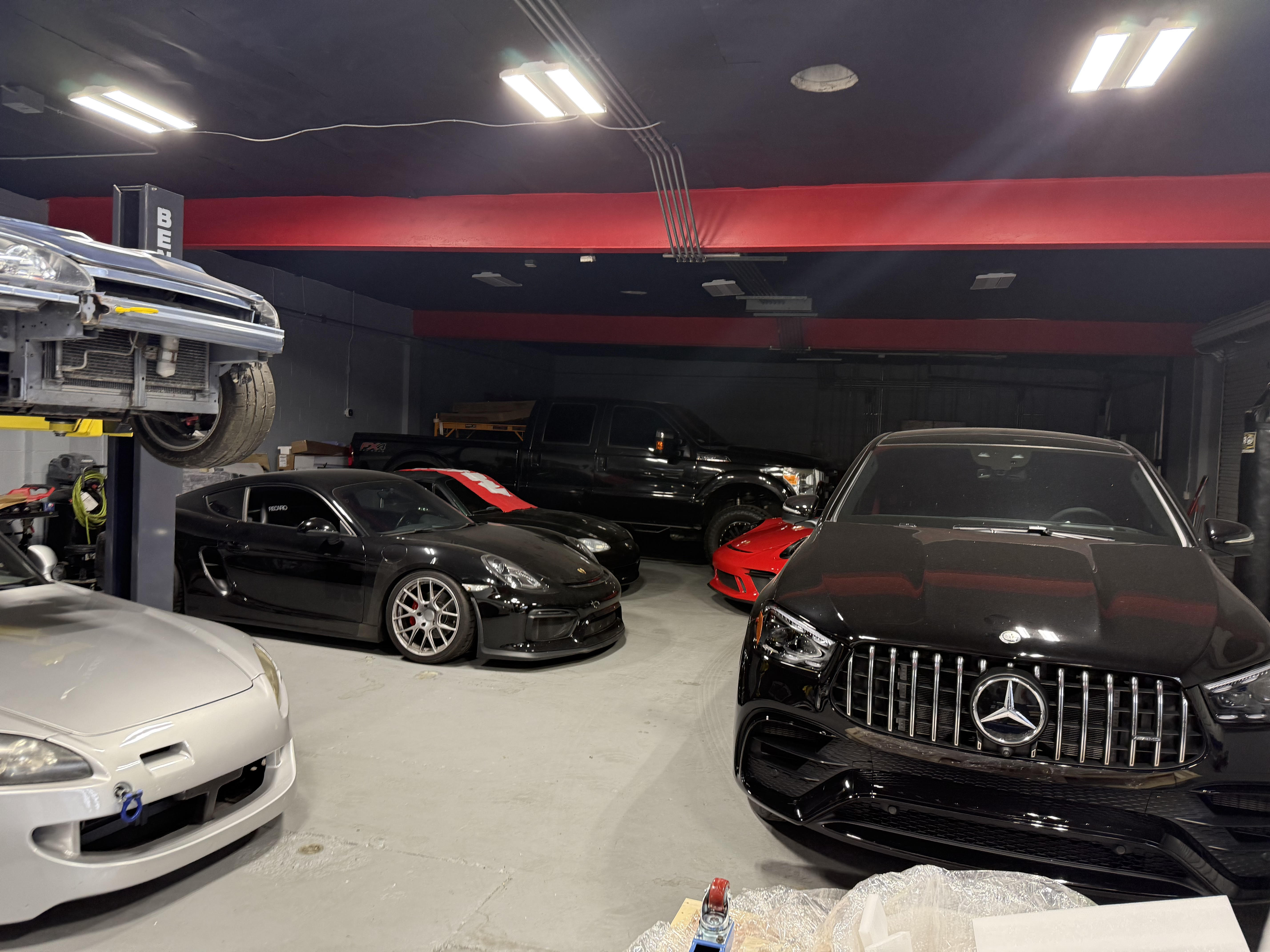 Track Tech shop floor with performance cars and lift